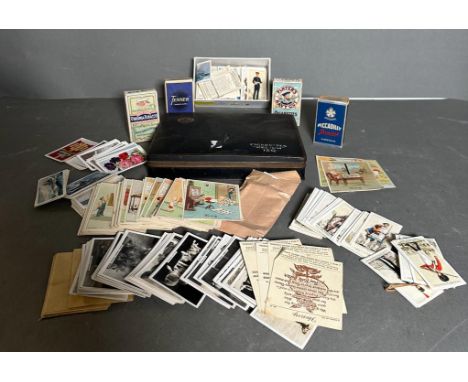 A quantity of loose and boxed cigarette cards various makers and ages and a vintage players cigarette tin 
