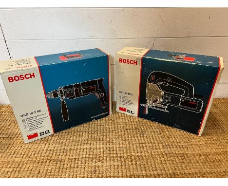 Two boxed Bosch power tools, a jigsaw and a impact drill 