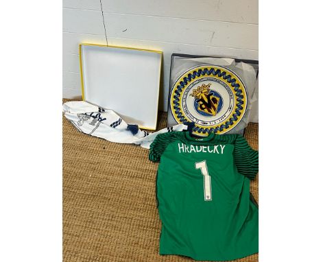 A signed Goal keepers shirt for Lukas Hradeck Finland National team, along with a plate from El Villarreal football club, for