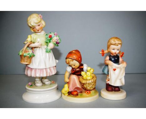 Three various German ceramic figures including Goebel, 3 figures, including Girl with Chickens, Girl washing clothes, and Gir