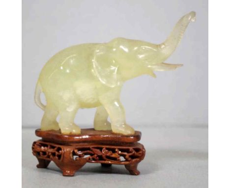 Chinese green stone elephant on wooden stand, 9cm high