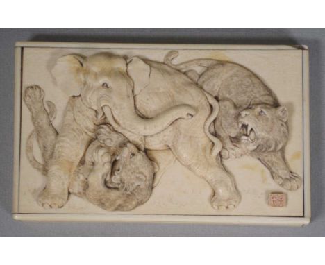 Japanese Meiji (1868-1912) period ivory lid with carved figures to top depicting an elephant being attacked by 2 tigers, 15cm