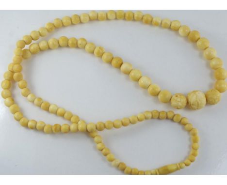 Good antique graduated ivory bead necklace circa 1920s, with three carved beads at the front, approx 70cm length,  Family hei
