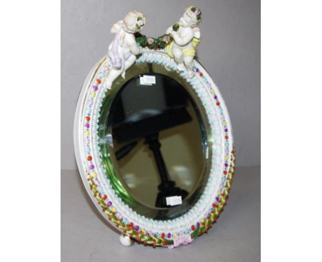 Vintage Continental porcelain table mirror applied putti figures to top of oval, ceramic framed mirror with bevelled edges, o