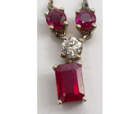Ruby, diamond and 18ct gold pendant and chain Handmade 18ct white gold hanging pendant set with a single approx 0.20ct round 