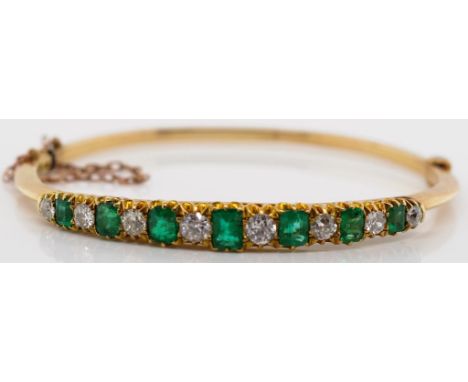 Antique diamond, emerald and 14ct gold bangle. A ladies hinged bangle with push button clasp and safety chain. Unmarked. Appr