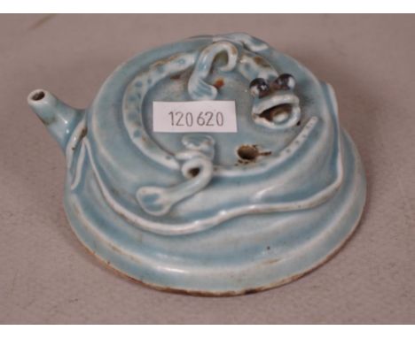 Chinese ceramic water dropper applied lizard decoration, on green ceramic ground. Diameter 8cm approx.