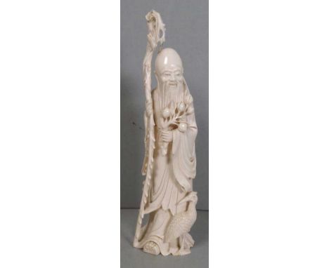 Chinese Republic (1912-1949) Shou Lao ivory figure the god of longevity, holding a staff in his right hand and a branch in hi