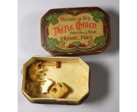 Four antique and other carved miniatures in a vintage perfume box