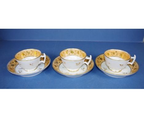 Three Georgian Coalport cups & saucers gilt on yellow ground, London shape, pattern number 2/486 to bases. Circa 1820.