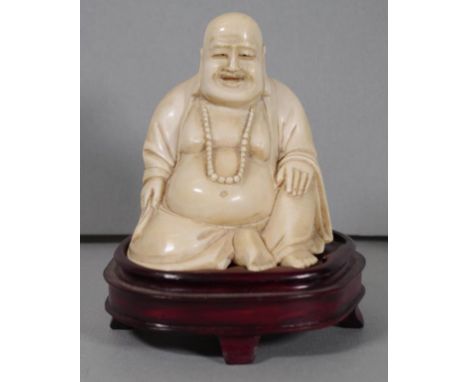 Chinese Republic (1912-1949) carved ivory Buddha signed to base, on carved wooden stand, 11cm high (total.) Ex: Private colle