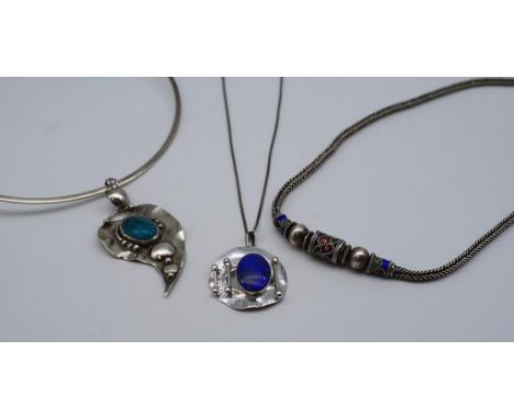 A well made silver and turquoise pendant on choker together with two silver necklaces. One with enamel and the other set with