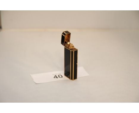 An old Cartier rectangular black enamel and gilt edged petrol lighter. Stamped Cartier Paris BA3970?, 7cm high