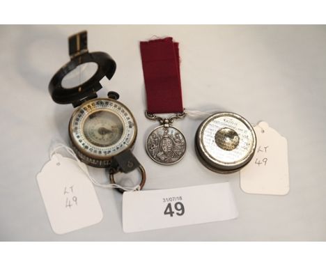 T.G Co Ltd military compass dated 1941, an anti dimming MK VI circular lidded tin (empty), victorian silver long service meda