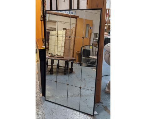 ARCHITECTURAL WALL MIRROR, segmented plate enclosed in black frame, gilt stud detail, 120cm x 70cm. 