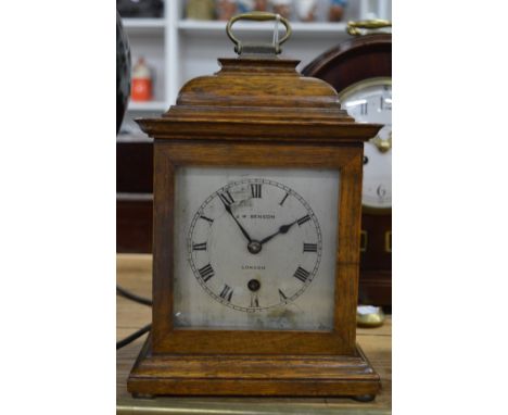 A small oak cased mantel clock.