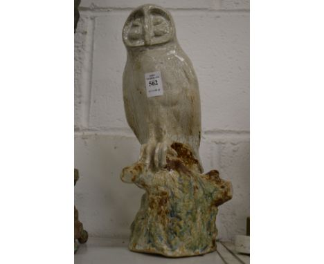 A Continental pottery model of an owl seated on a tree stump.