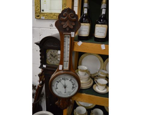 An oak barometer/thermometer.