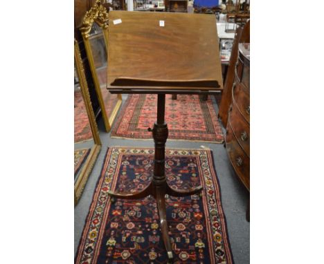 A 19th century mahogany adjustable music stand with tripod base.