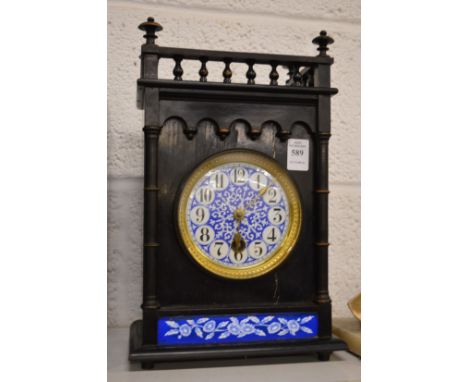 A Victorian aesthetic movement mantel clock with blue and white enamel dial.
