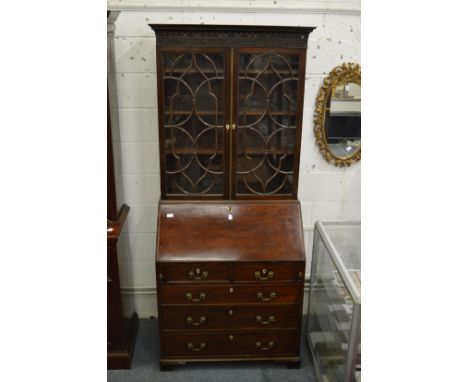 A good Chippendale style mahogany bureau bookcase with well fitted interior and carved decoration.