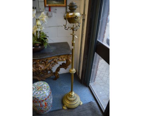 A Victorian brass telescopic floor standing oil lamp.