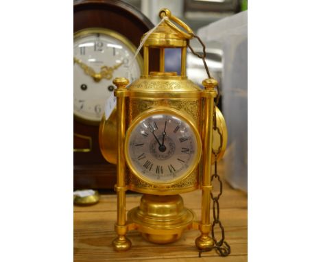 An unusual brass combination clock, barometer and thermometer.