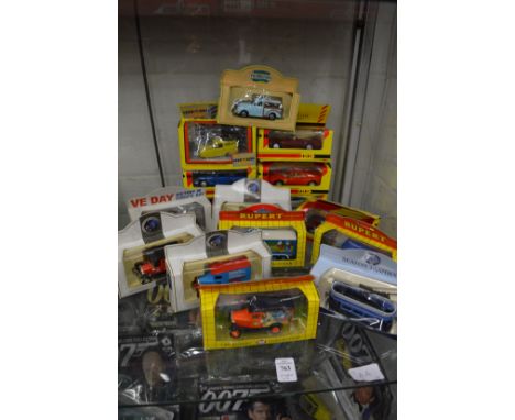 A quantity of boxed model vans and cars.