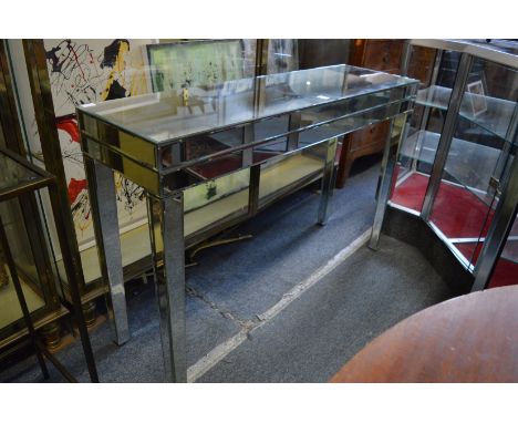 A stylish mirrored console table, damage to one leg.