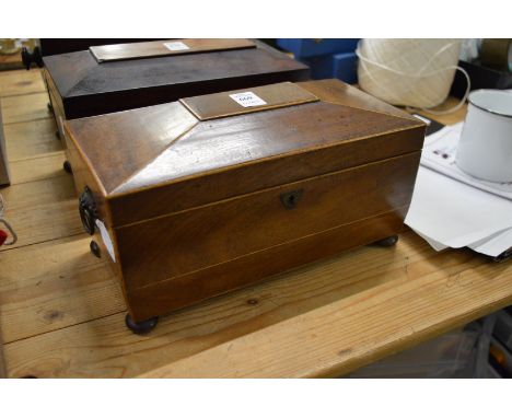 A Victorian mahogany sarcophagus shaped tea caddy.