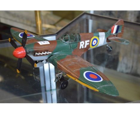 A painted metal model of an aeroplane.