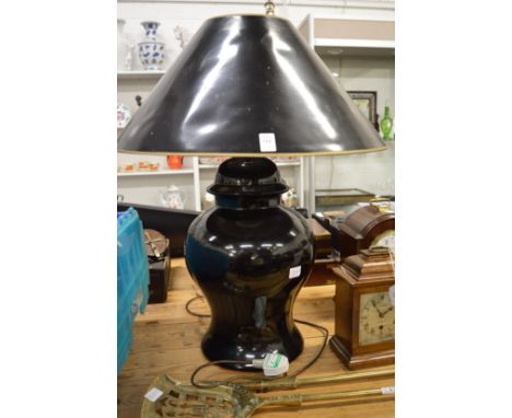 A large black pottery table lamp and shade.