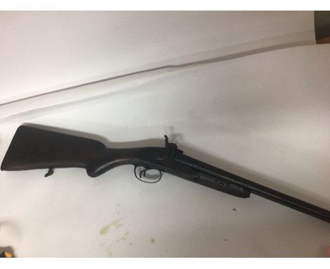 An Antique muzzle load hammer percussion double barrel shot gun. Non functional and for wall ornamentation.