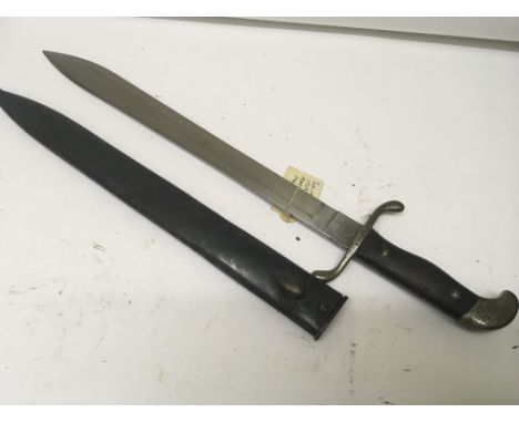 A Short Sword with butcher type steel blade wood grip the blade stamped Modelo Argentino 1909 the cross guard and scabbard wi