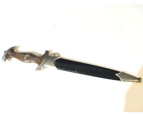 A German Third Reich II world war SA dagger with walnut grip makers stamp to the blade and conforming engraved numbering to t