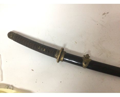 A 20th Century Japanese samurai sword with brass fittings bound grip lacquer scabbard and signed blade. Length 100cm.