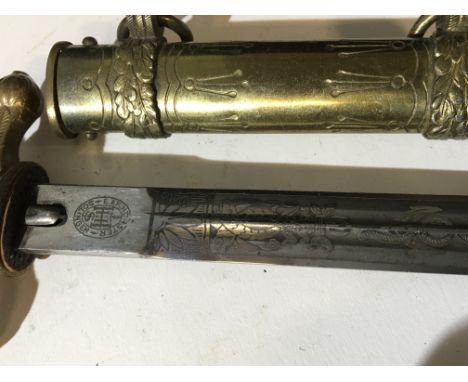 A German Third Reich Kriegsmarine officers presentation dagger the decorated blade with makers marks brass scabbard with furt