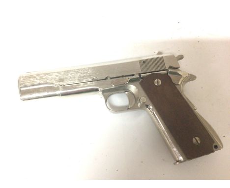 A Japanese made Chrome finish replica, non firing pistol.An American Army colt M191.