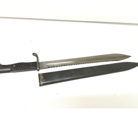 A German I world war bayonet the 98/05S pattern with wooden grip with a sawback edge blade the blade stamped with a Berlin ma