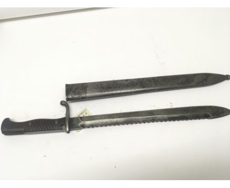 A German sawback edge Mauser bayonet with wood grip the blade stamped with makers marks and with steel scabbard. length 52cm