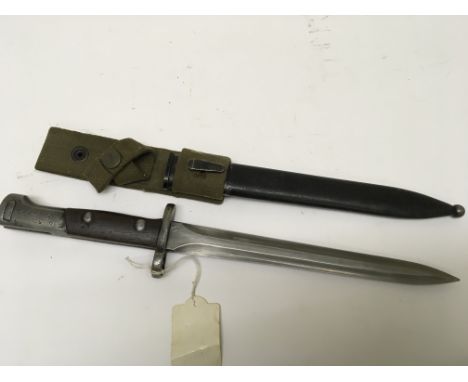 A German Imperial Colonial overseas forces bayonet S71/84 with a wood and steel grip stamped SA30 with a green canvas frog me