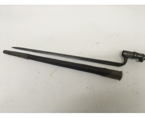 A 19th century Spike socket bayonet with leather and brass scabbard the socket with numbers.