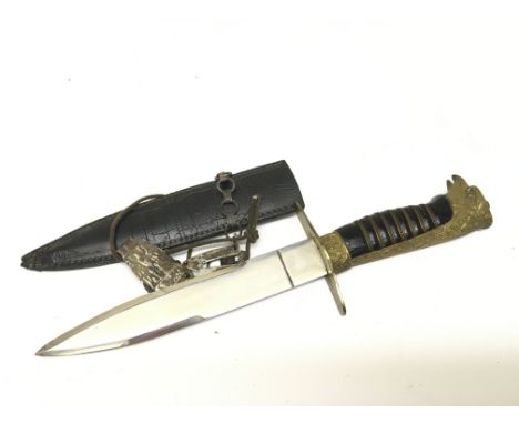 An unusual German Third Reich type dagger with an eagle head pomel with gilt metal glass eyes and wired grip with attached fi