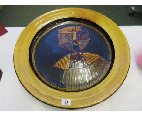 PLYMOUTH POTTERY, an amusing slip glazed large portrait charger, 18.5" diameter 