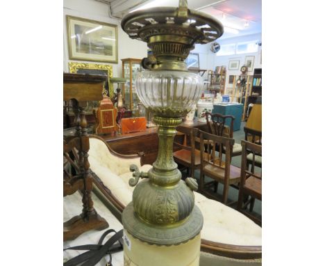 OIL LAMP, an ornate brass base oil lamp with floral painted ceramic body and cut glass reservoir 
