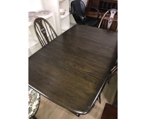 ERCOL EXTENDING DINING TABLE AND 4 SPINDLE BACK WITH SWAN MEDALLION CHAIRS