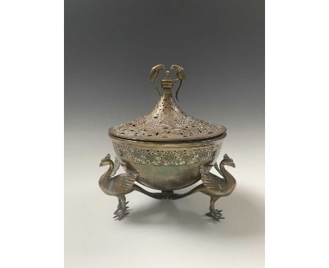 A Persian brass brazier, late 19th century, the pierced cover surmounted by a bird finial, the base with a pierced band of fl