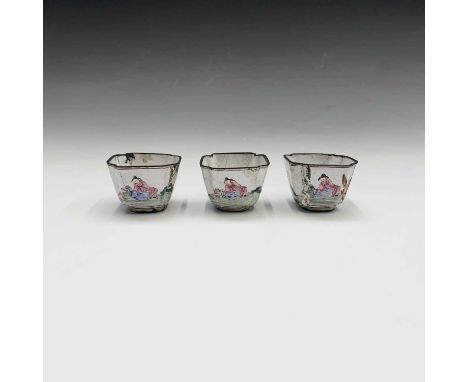 A set of three Chinese enamel famille rose wine cups, 18th century, each decorated with three figures in a landscape surround