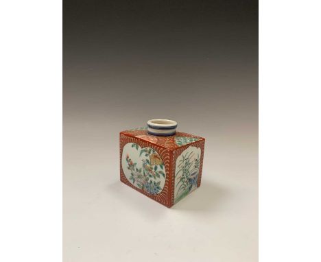 A Japanese porcelain inkwell, 19th century, of rectagular form, the white ground cartouches each with a bird perched on a flo