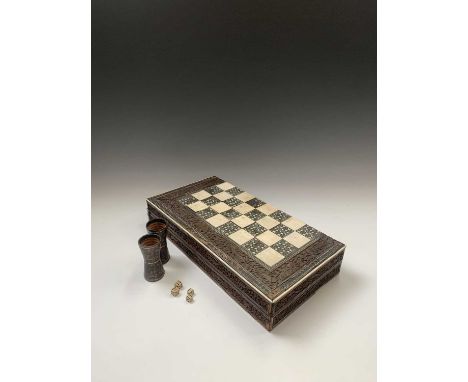 An Anglo-Indian sandalwood games board, 19th century, with ivory and sadeli chess squares within a border carved with animals